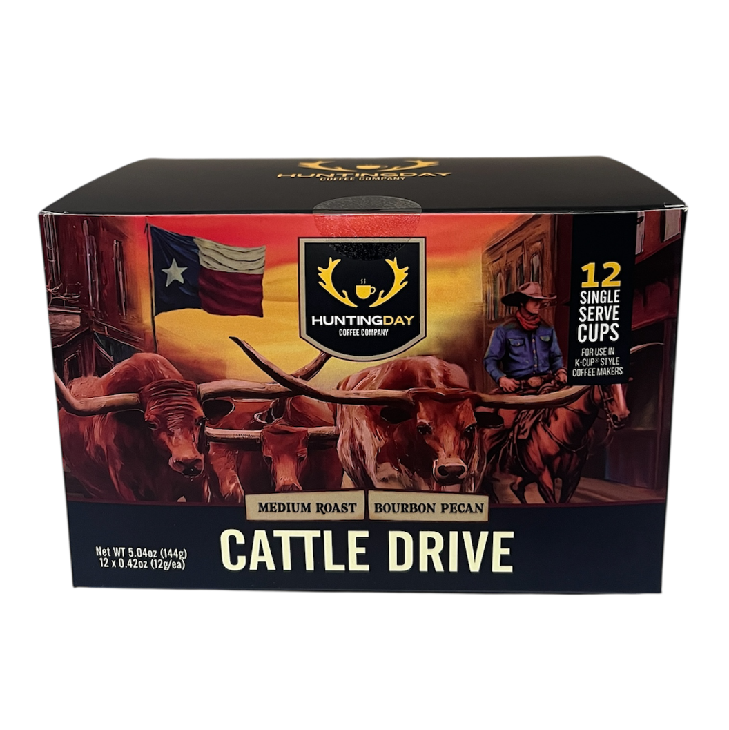 A boxed beverage product labeled HARTMODAY CATTLE DRIVE, shown against a plain white background. The box features a western illustration with longhorns, an American flag, a cowboy in a blue shirt, and the text 'CATTLE DRIVE' and 'MEDIUM ROAST BOURBON PEANUT'.