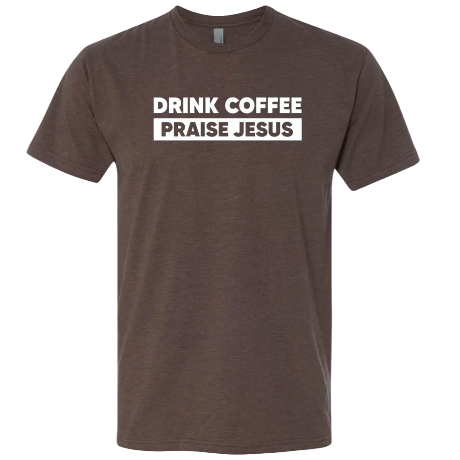 A dark brown heather crewneck t-shirt with a white graphic print on the chest that reads 'DRINK COFFEE PRAISE JESUS' in bold uppercase letters, shown against a plain white background.