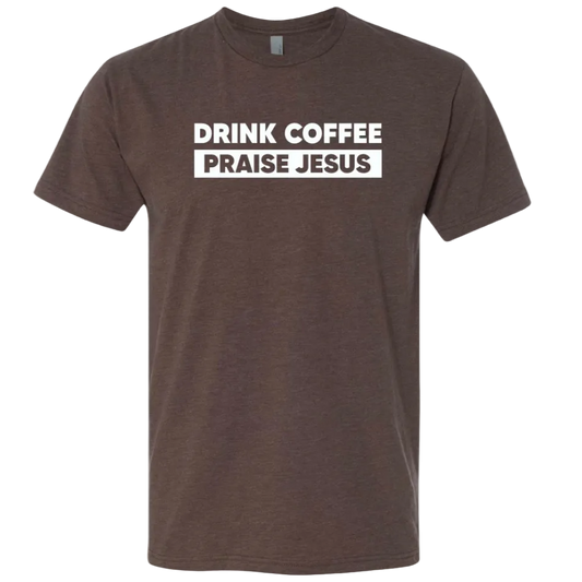 A dark brown heather crewneck t-shirt with a white graphic print on the chest that reads 'DRINK COFFEE PRAISE JESUS' in bold uppercase letters, shown against a plain white background.