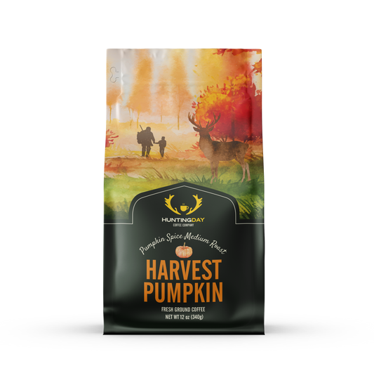 A bag of Hunting Day Coffee's Harvest Pumpkin coffee, featuring a dark green lower half with orange text and a watercolor autumn scene on the upper half.