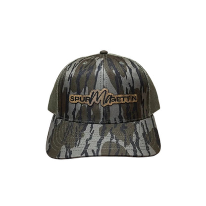 Camouflage-patterned cap with a brand logo