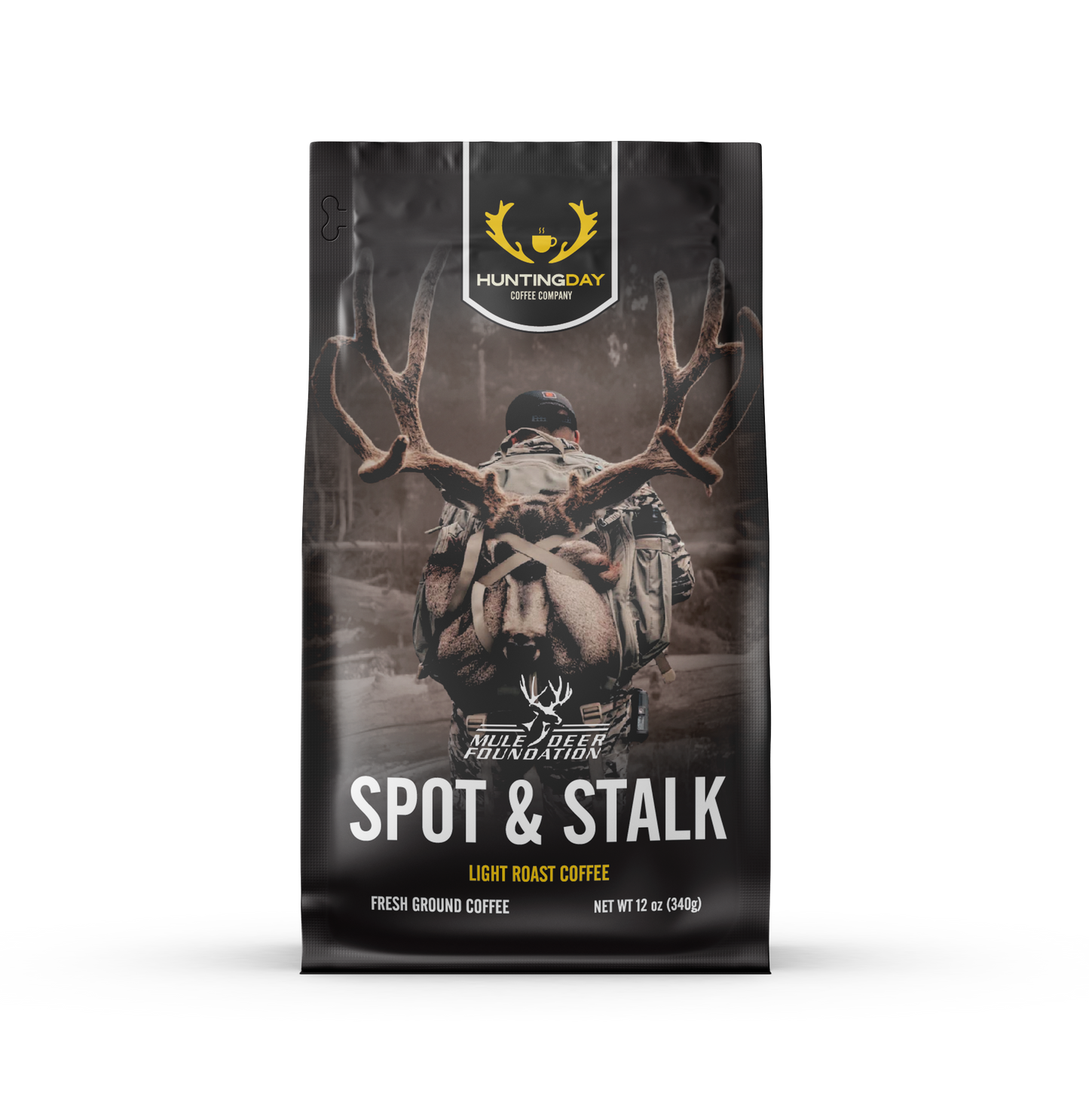 A 12 oz bag of Huntingday Spot & Stalk light roast coffee, featuring a dark, moody graphic of a deer with large antlers on a forest background.